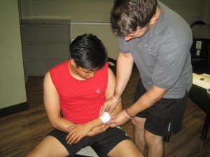 Applying Gauze for a Cut on the Arm